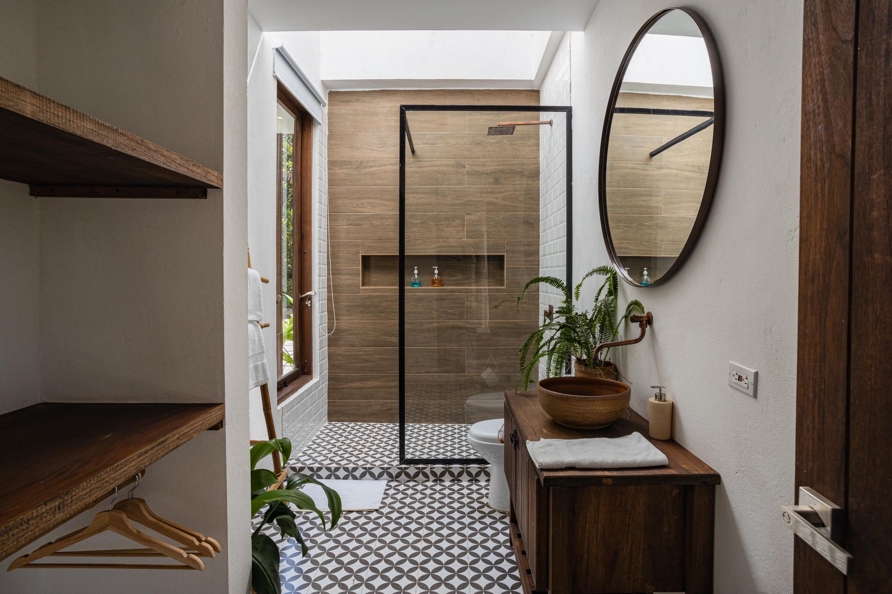 Modern bathroom with a glass walk-in shower and patterned tile floor